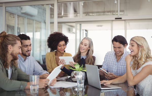 Happy business people working together at creative office desk Happy business people working together at creative office desk